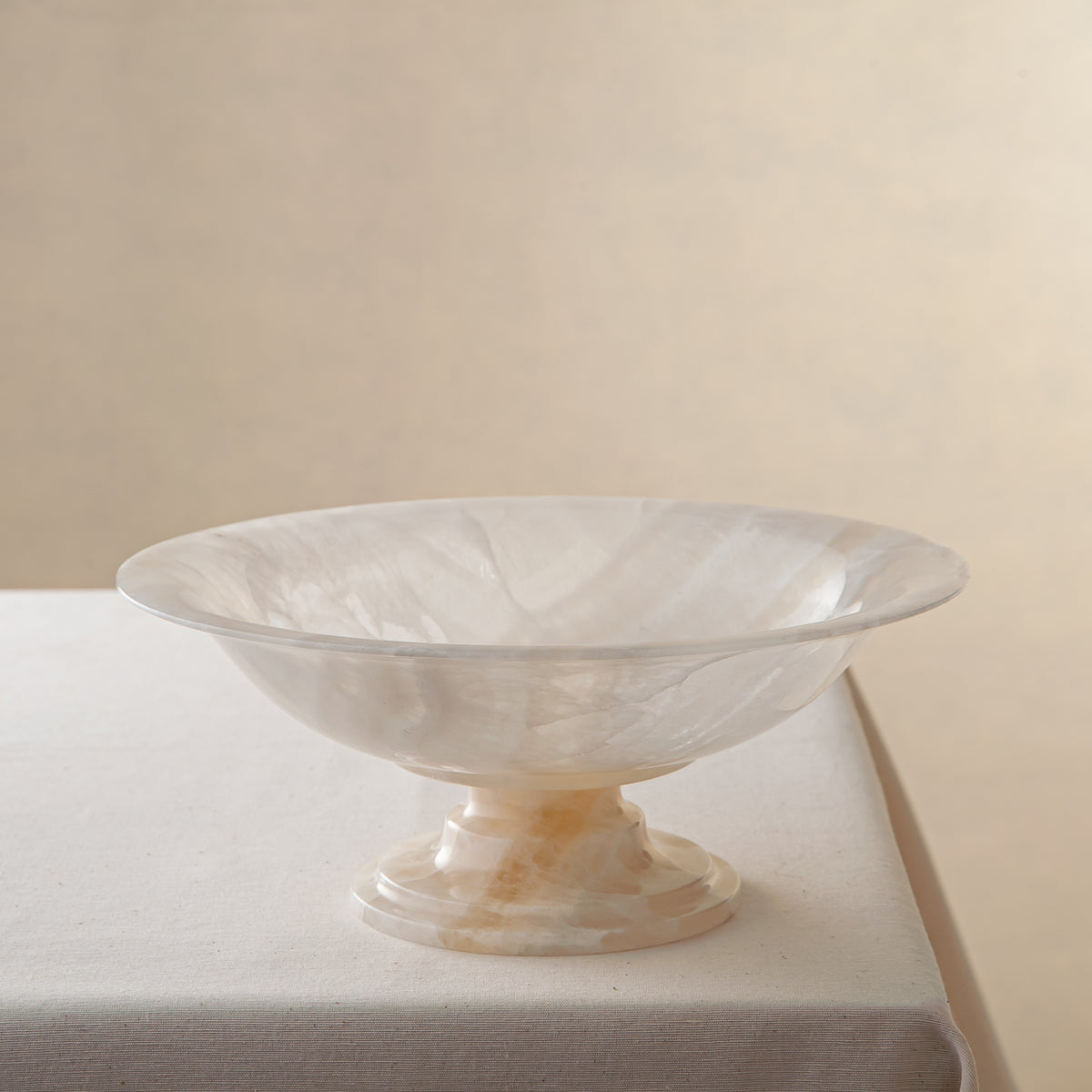 handcrafted onyx bowl with pedestal base translucent white stone and warm amber veining for centerpiece
