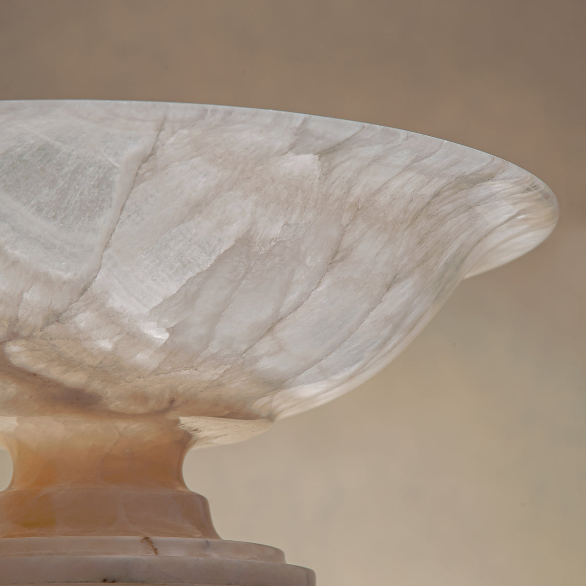 handcrafted onyx bowl with pedestal base translucent white stone and warm amber veining for centerpiece
