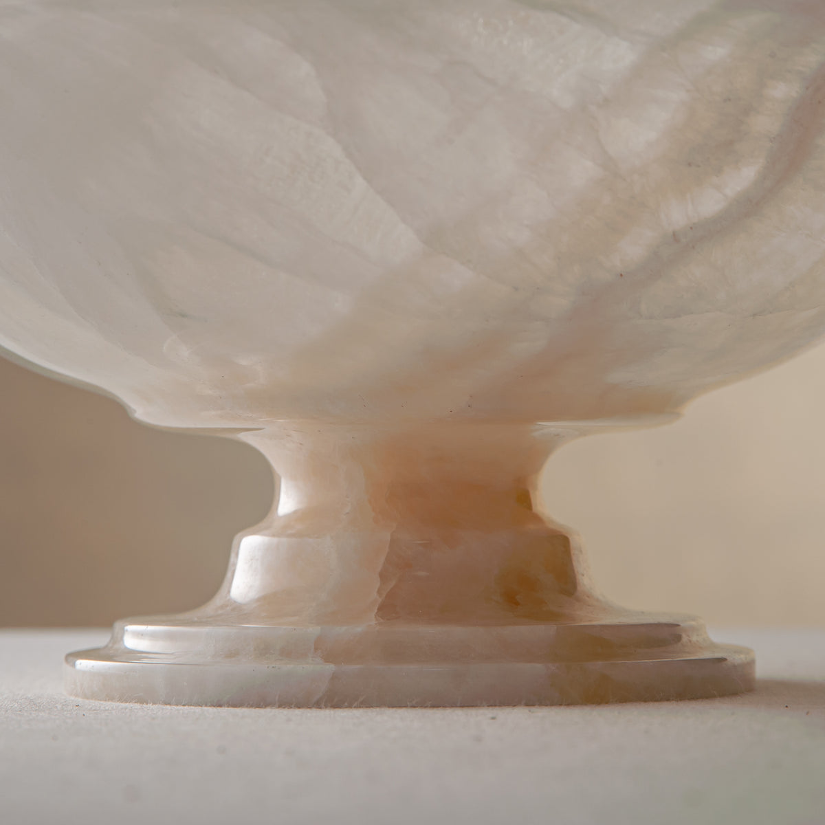 handcrafted onyx bowl with pedestal base translucent white stone and warm amber veining for centerpiece
