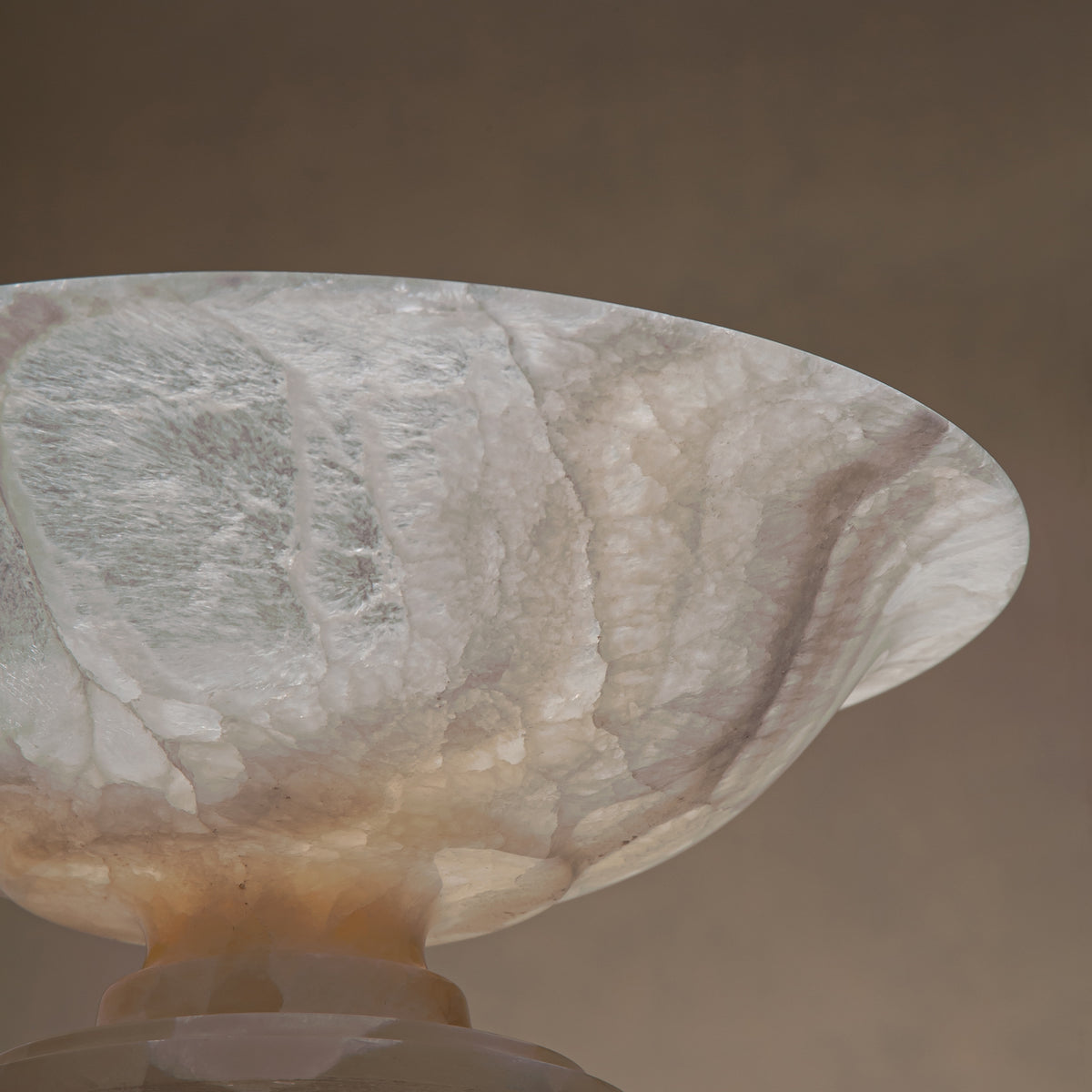 handcrafted onyx bowl with pedestal base translucent white stone and warm amber veining for centerpiece
