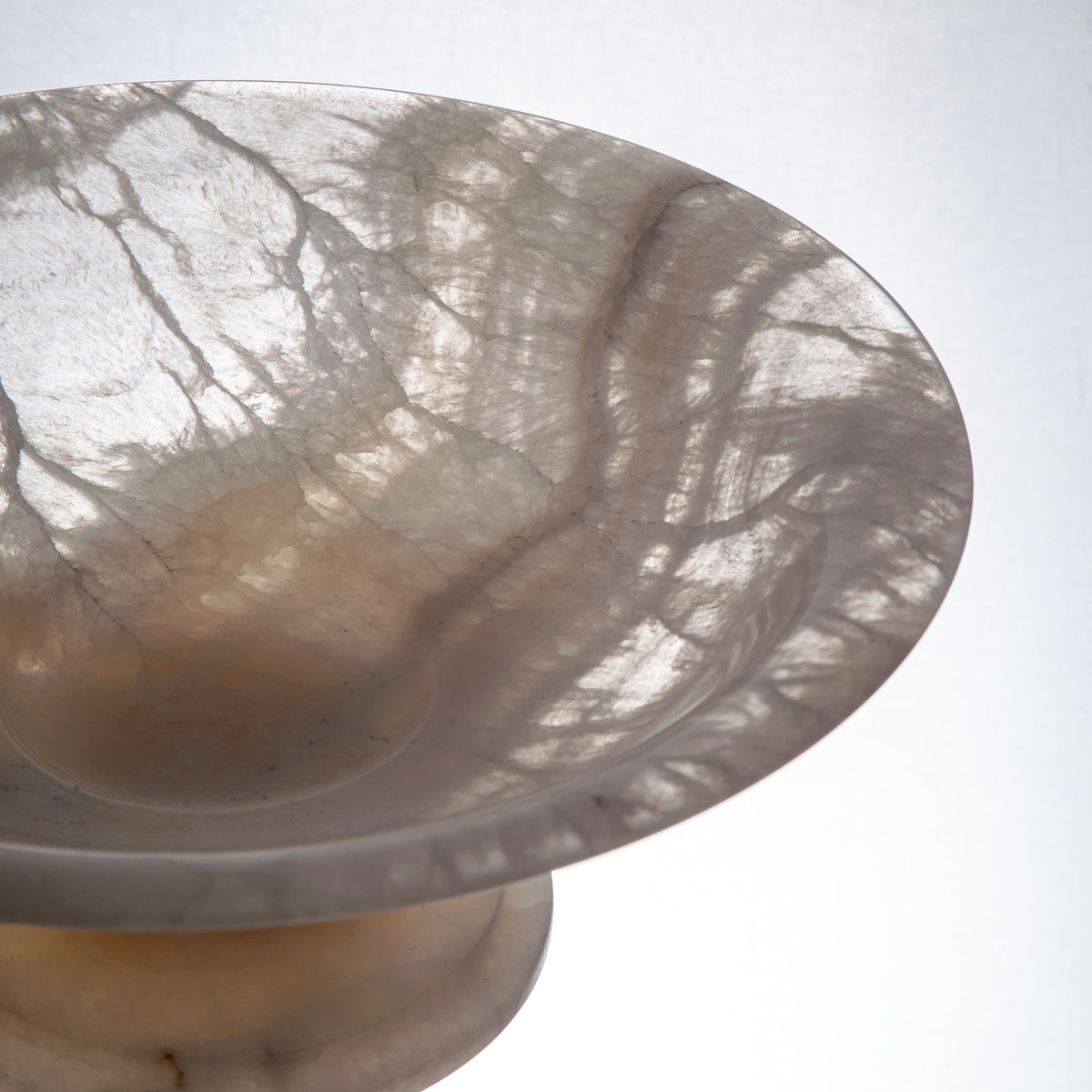 handcrafted onyx bowl with pedestal base translucent white stone and warm amber veining for centerpiece
