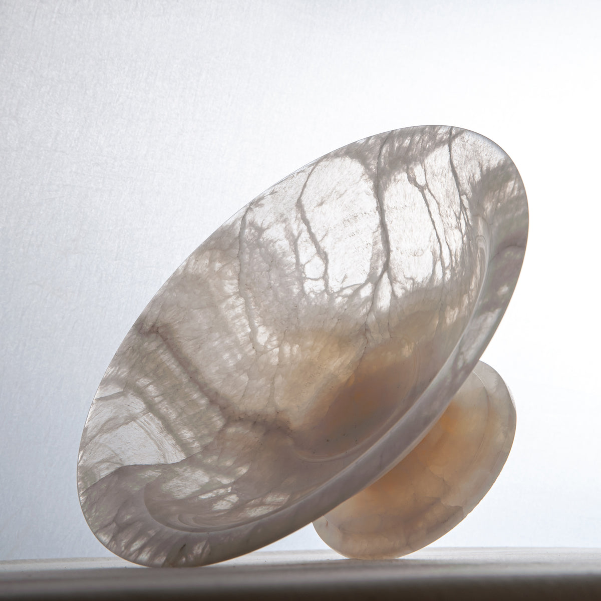 handcrafted onyx bowl with pedestal base translucent white stone and warm amber veining for centerpiece

